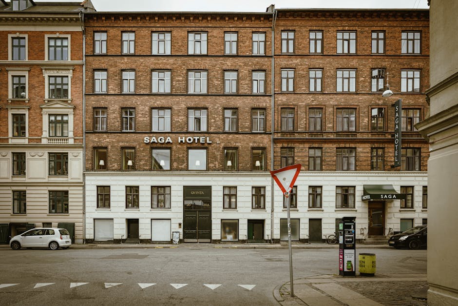 Historic brick hotel facade in Copenhagen's city street, showcasing classic architecture.