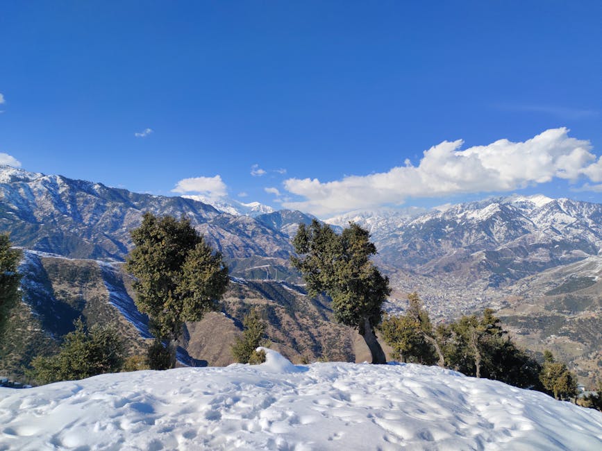 Breathtaking view of snow-covered mountains under a clear blue sky.