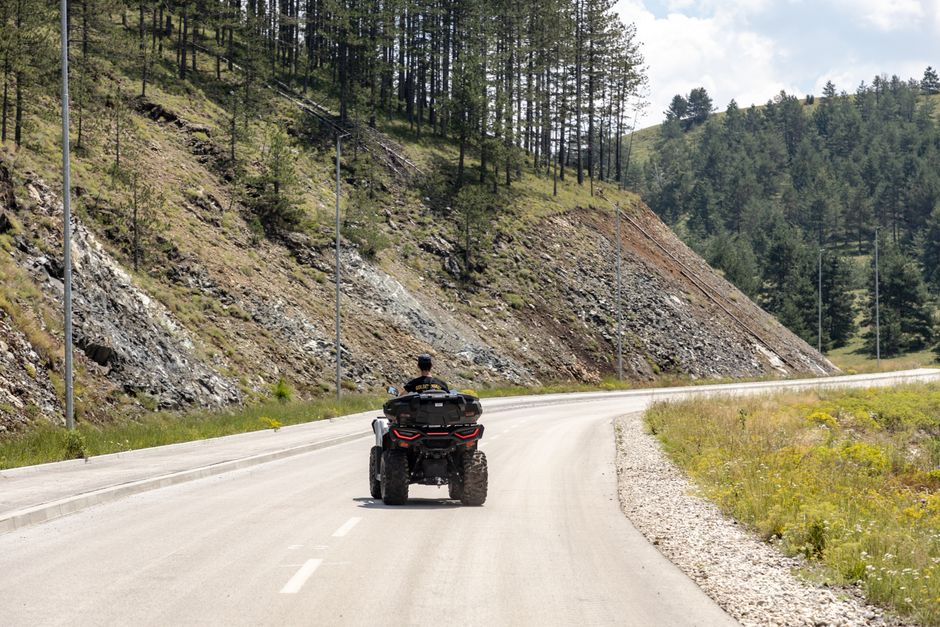 Enjoy the thrill of ATV adventure on a winding road amidst lush green forests in Zlatibor, Serbia.