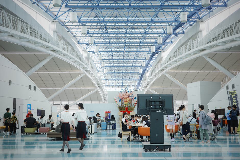 Spacious and bustling Fukuoka Airport lobby showcasing modern architecture and travelers.
