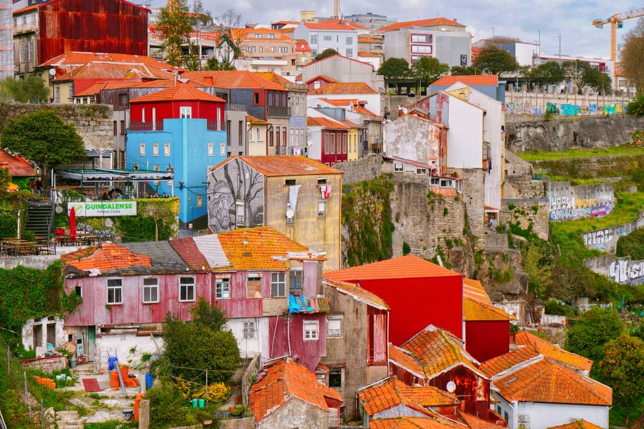 Colorful houses and graffiti in Porto create a vivid urban landscape, showcasing the city's unique charm.