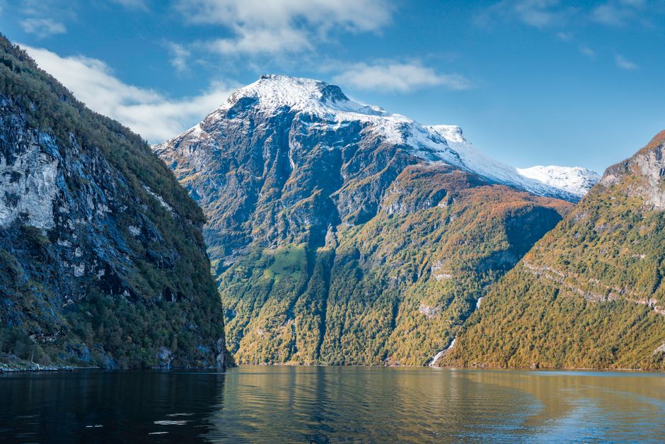 Breathtaking view of a snow-capped mountain and fjord in Norway, perfect for nature lovers.