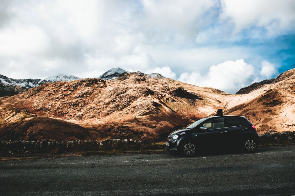 Car traveling through the stunning landscapes of Snowdonia in Wales.
