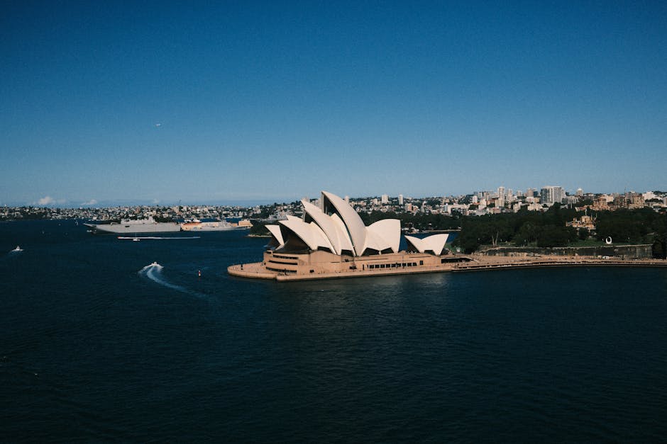 Aerial view of Sydney Opera House with Sydney Harbour and city skyline.