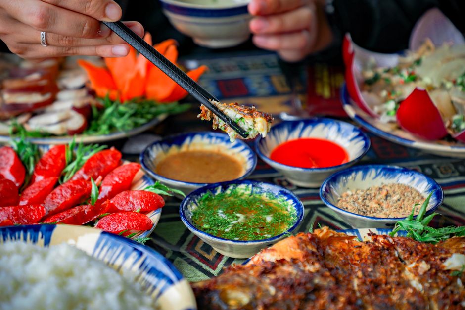 A colorful Asian meal featuring various dishes and sauces, artfully arranged for a delightful dining experience.